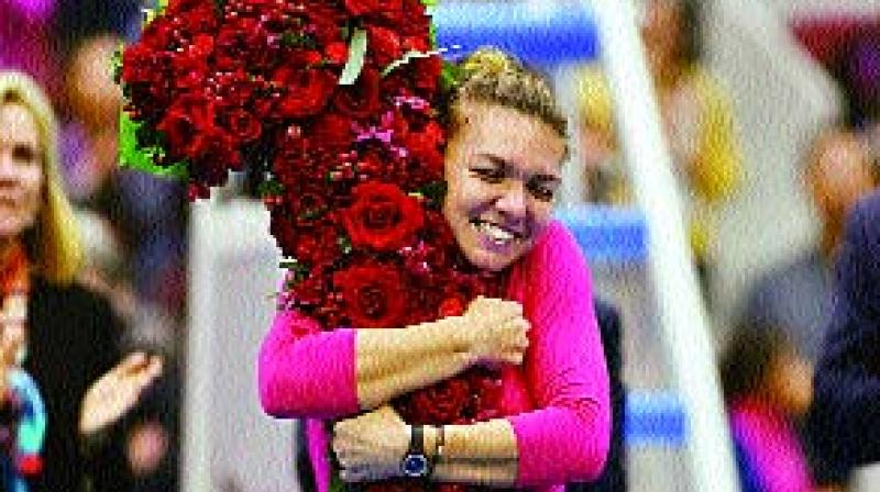 Simona Halep celebrates after taking the top ranking upon reaching the China Open final on Saturday (Photo: AFP) Simona Halep celebrates after taking the top ranking upon reaching the China Open final on Saturday (Photo: AFP)