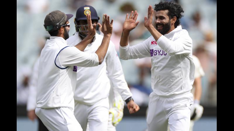 Indias Ravindra Jadeja (right) celebrates after taking the wicket of Australias Matthew Wade on Day Three of the second Test in Melbourne on Monday. 	 AP