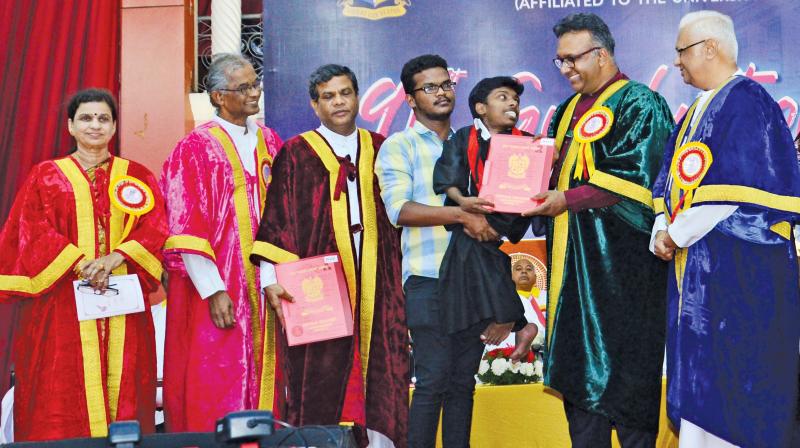 Carried by his kind roommate Immanuel, dwarf S Vincent is all smiles as he receives his medal and the B.A. (History) degree from chief guest Prof C. Raj Kumar, Founding Vice-Chancellor, O P Jindal Global University. (Image DC) Carried by his kind roommate Immanuel, dwarf S Vincent is all smiles as he receives his medal and the B.A. (History) degree from chief guest Prof C. Raj Kumar, Founding Vice-Chancellor, O P Jindal Global University. (Image DC)