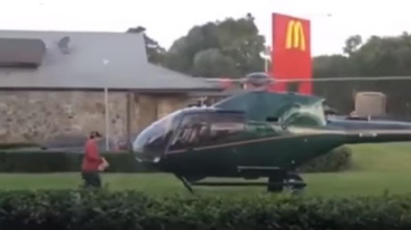 The man stopped by the Sydney McDonald's to pick up a parcel and flew off after he clicked a photograph of it. (Photo: Youtube) The man stopped by the Sydney McDonald's to pick up a parcel and flew off after he clicked a photograph of it. (Photo: Youtube)