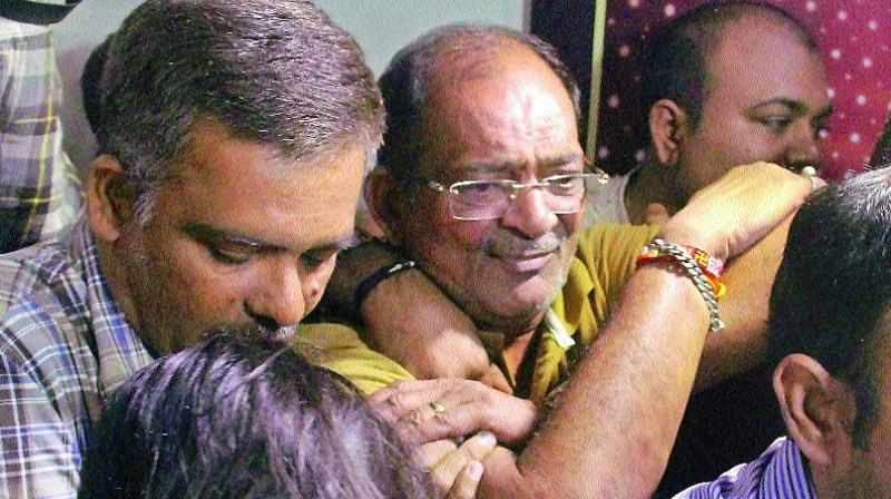 Police and Income tax officials with the land dealer Mahesh Shah who declared `13,860 crore under IDS, in Ahmedabad on Saturday. (Photo: PTI) Police and Income tax officials with the land dealer Mahesh Shah who declared `13,860 crore under IDS, in Ahmedabad on Saturday. (Photo: PTI)