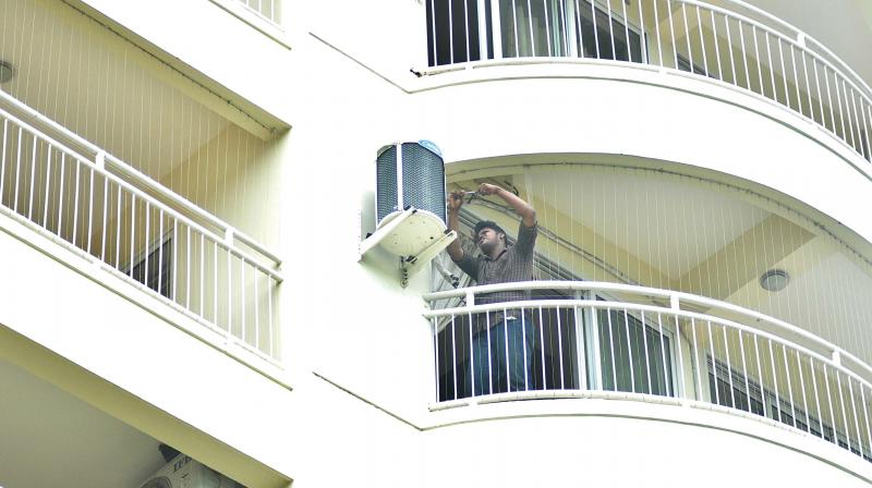 A mechanic dismantles the air-conditioner from an apartment before vacating the flats, in Kochi on Sunday (Photo: SUNOJ NINAN MATHEW) A mechanic dismantles the air-conditioner from an apartment before vacating the flats, in Kochi on Sunday (Photo: SUNOJ NINAN MATHEW)
