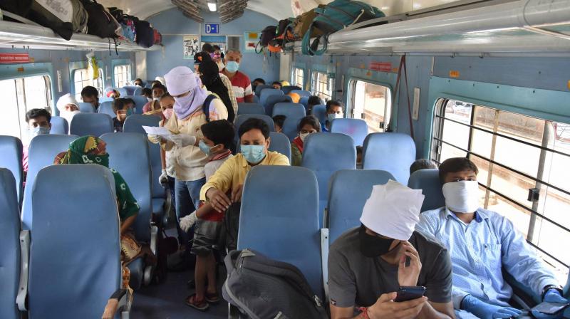 Passengers sit in a train to reach their destination, during the ongoing COVID-19 lockdown. PTI photo