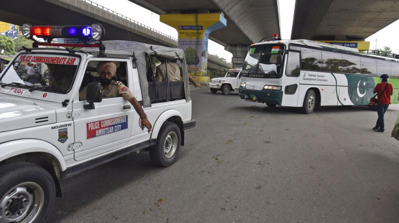 Punjab Police escort a Pakistan Tourism Development Corporation bus as it returns to Lahore without passengers, in Amritsar, India, on Saturday, August 10. (Photo: AP) Punjab Police escort a Pakistan Tourism Development Corporation bus as it returns to Lahore without passengers, in Amritsar, India, on Saturday, August 10. (Photo: AP)