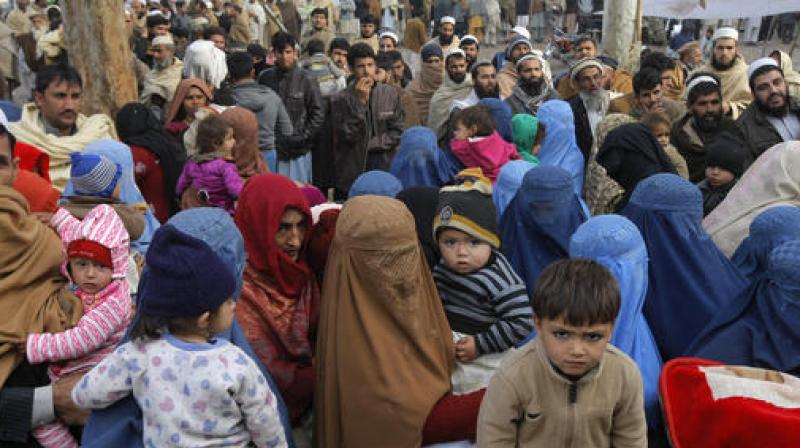 Afghan refugee families wait for their turn to be registered, outside the government registration office in Peshawar, Pakistan. (Photo: AP) Afghan refugee families wait for their turn to be registered, outside the government registration office in Peshawar, Pakistan. (Photo: AP)