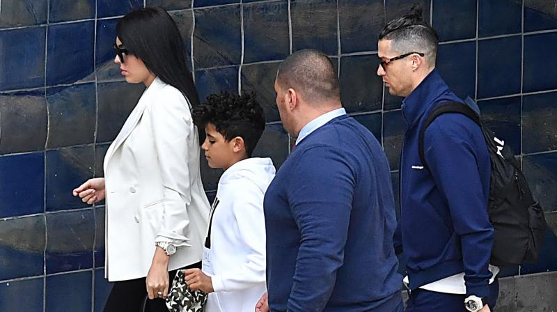 Juventus star Cristiano Ronaldo, his partner Georgina Rodriguez and son Cristiano Jr arrive at Madeira airport in Funchal, Portugal, on Monday. AFP Photo