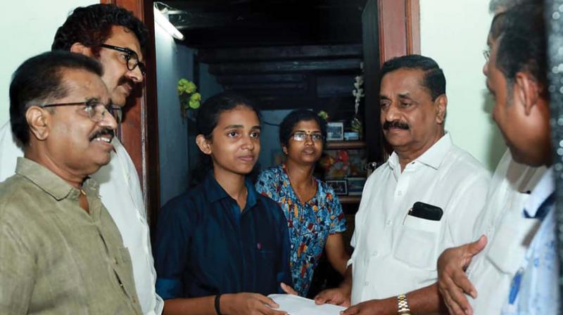Mayor Thottathil Raveendran handing over the first instalment of the monthly treatment aid of Save Green, a city-based organisation, to Arya at Malaparamba, Kozhikode on Thursday. Mayor Thottathil Raveendran handing over the first instalment of the monthly treatment aid of Save Green, a city-based organisation, to Arya at Malaparamba, Kozhikode on Thursday.