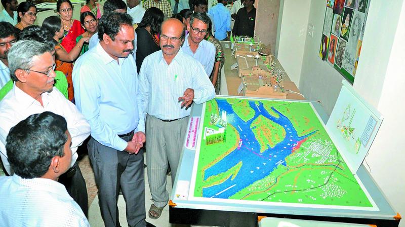APCRDA commissioner Ch. Sreedhar, along with Acharya Nagarajuna University Vice-Chancellor Prof. A.Rajendra watches the models displayed at Anubhoothi - 2016 at Acharya Nagrajuna University in Guntur district on Friday. (Photo: DC) APCRDA commissioner Ch. Sreedhar, along with Acharya Nagarajuna University Vice-Chancellor Prof. A.Rajendra watches the models displayed at Anubhoothi - 2016 at Acharya Nagrajuna University in Guntur district on Friday. (Photo: DC)
