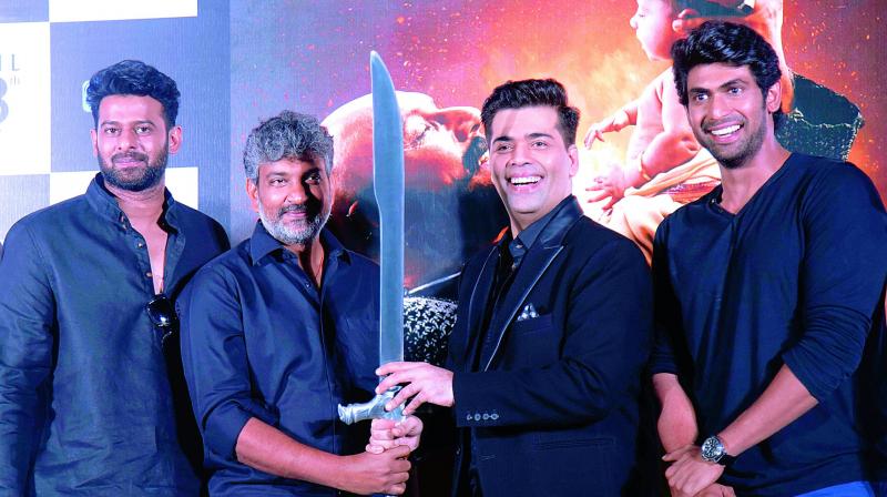 A gift to cherish: Prabhas, S.S. Rajamouli and Rana Daggubati present Karan Johar with the sword that was used by Katappa in the movie to kill Baahubali A gift to cherish: Prabhas, S.S. Rajamouli and Rana Daggubati present Karan Johar with the sword that was used by Katappa in the movie to kill Baahubali