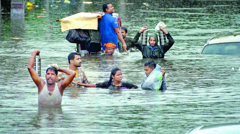 People relocate to a safer place with their belongings as their houses get flooded following heavy monsoon rainfall in Patna on Sunday. Battered by heavy rainfall for the third consecutive day, 18 persons were killed in Bihar on Sunday in mishaps caused by the downpour that inundated streets, waterlogged railway tracks and marooned business establishments. (PTI) People relocate to a safer place with their belongings as their houses get flooded following heavy monsoon rainfall in Patna on Sunday. Battered by heavy rainfall for the third consecutive day, 18 persons were killed in Bihar on Sunday in mishaps caused by the downpour that inundated streets, waterlogged railway tracks and marooned business establishments. (PTI)