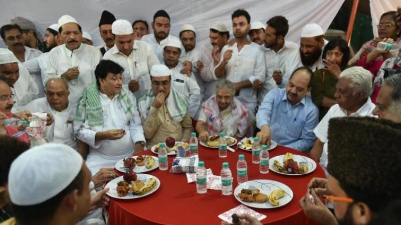DPCC President Ajay Maken and Delhi's former chief minister Sheila Dikshit along with other leaders and Muslim people at a Roza Iftar party organised at Delhi Pradesh Congress Committee office, in New Delhi on Sunday, June 10, 2018. (Photo: PTI) DPCC President Ajay Maken and Delhi's former chief minister Sheila Dikshit along with other leaders and Muslim people at a Roza Iftar party organised at Delhi Pradesh Congress Committee office, in New Delhi on Sunday, June 10, 2018. (Photo: PTI)