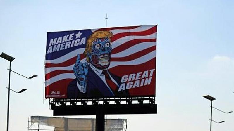 A billboard by US artist Mitch O'Connell depicting President Donald Trump displayed in Mexico City is in allusion and tribute to John Carpenter's 1988 cult movie "They Live". (Photo: AFP) A billboard by US artist Mitch O'Connell depicting President Donald Trump displayed in Mexico City is in allusion and tribute to John Carpenter's 1988 cult movie "They Live". (Photo: AFP)