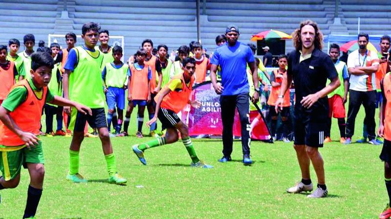 Carles Puyol (second from right) with school children at the Mission XI Million festival on Wednesday. (Photo: AP) Carles Puyol (second from right) with school children at the Mission XI Million festival on Wednesday. (Photo: AP)