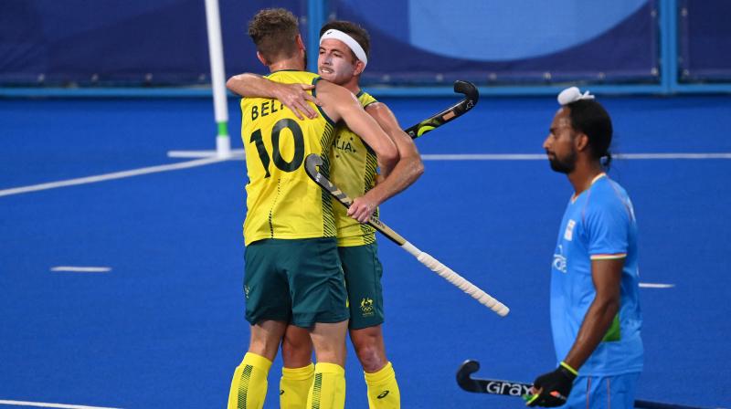 Australias Joshua Beltz (left) and Jacob Thomas Whetton Australias celebrate after teammate Daniel James Beale (out of frame) scored against India during their mens pool A match of the Tokyo Olympic Games field hockey competition, at the Oi Hockey Stadium in Tokyo on Sunday. (Photo: AFP)