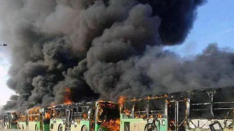 In this photo released by the Syrian official news agency SANA, smoke rises in green government buses, in Idlib province, Syria. (Photo: AP) In this photo released by the Syrian official news agency SANA, smoke rises in green government buses, in Idlib province, Syria. (Photo: AP)