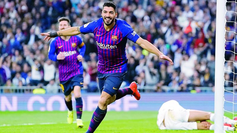 Barcelona forward Luis Suarez celebrates after Real defender Raphael Varane scores an own goal during their Copa del Rey semifinal second leg at the Bernabeu stadium in Madrid on Wednesday. Barcelona won 3-0. (Photo: AP) Barcelona forward Luis Suarez celebrates after Real defender Raphael Varane scores an own goal during their Copa del Rey semifinal second leg at the Bernabeu stadium in Madrid on Wednesday. Barcelona won 3-0. (Photo: AP)