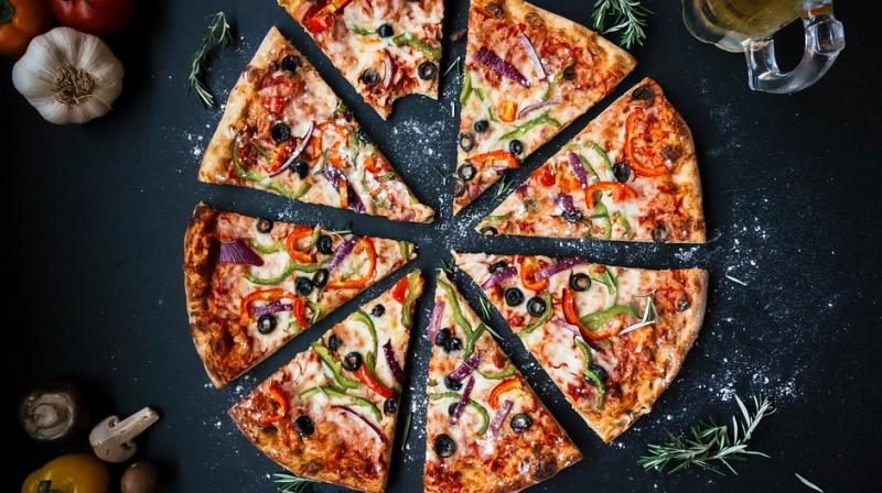 To get free pizza, a group of at least four people have to eat pizza at the restaurant. (Photo: File) To get free pizza, a group of at least four people have to eat pizza at the restaurant. (Photo: File)
