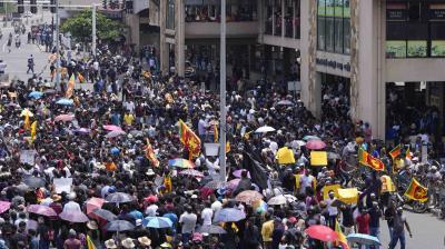Anti Government protesters shout slogans outside the Galle International Cricket Stadium during the second day of the second test cricket match between Australia and Sri Lanka in Galle, Sri Lanka, Saturday, July 9, 2022. (AP Photo/Eranga Jayawardena)