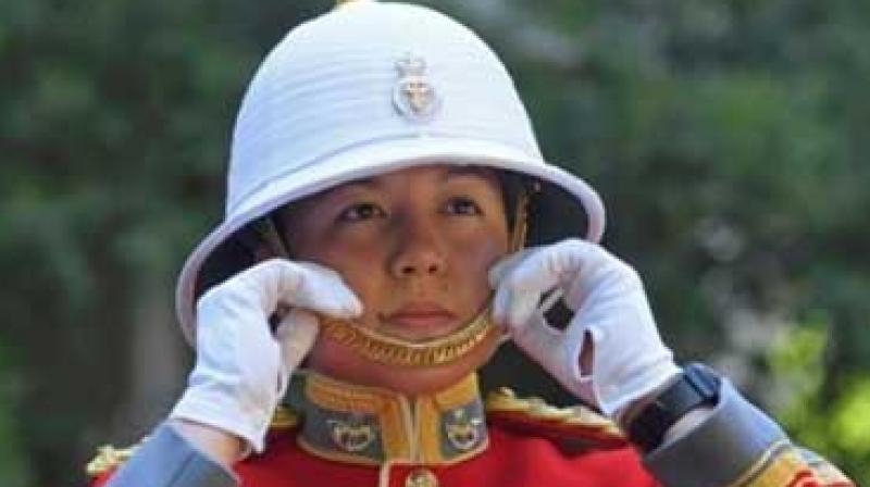 Carrying her sword and wearing a scarlet tunic and white hat, Couto marched her troops to Buckingham Palace from the nearby Wellington Barracks in the historic and colourful ceremony. (Photo: AP) Carrying her sword and wearing a scarlet tunic and white hat, Couto marched her troops to Buckingham Palace from the nearby Wellington Barracks in the historic and colourful ceremony. (Photo: AP)