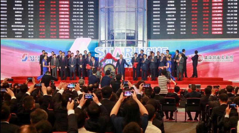 People take pictures during an opening ceremony of the Shanghai Stock Exchange’s Sci-Tech Innovation Board or STAR Market in Shanghai on July 22, 2019. (Photo: AP) People take pictures during an opening ceremony of the Shanghai Stock Exchange’s Sci-Tech Innovation Board or STAR Market in Shanghai on July 22, 2019. (Photo: AP)