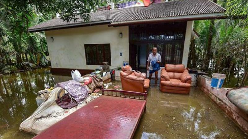 A man cleans up his house after flood water subsided, in Puthenvelikkara near Kochi. (Photo: PTI) (Photo: PTI) A man cleans up his house after flood water subsided, in Puthenvelikkara near Kochi. (Photo: PTI) (Photo: PTI)
