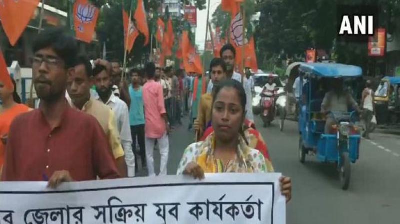 BJP Yuva Morcha workers took out a protest, on Wednesday, against the alleged killing of a 30-year-old man, who is now being claimed by both parties as their cadre. (Photo: ANI) BJP Yuva Morcha workers took out a protest, on Wednesday, against the alleged killing of a 30-year-old man, who is now being claimed by both parties as their cadre. (Photo: ANI)
