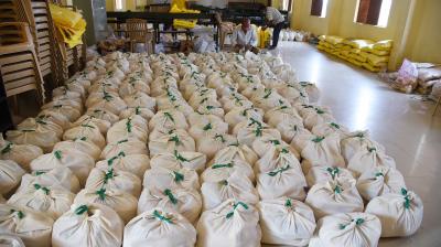 Bags containing essential supplies kept ready for distribution to people at te Uttarahalli Government School in Bengaluru on Saturday. (DC Photo: Satish. B)