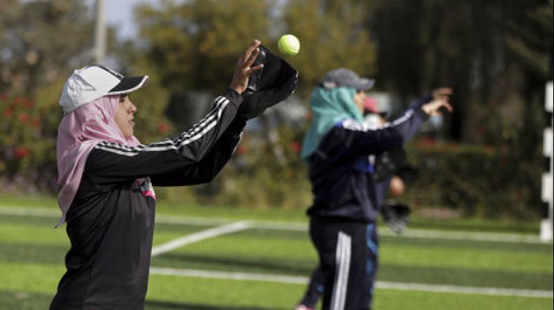 Palestinian women practice with tennis balls while training for an all women's baseball game, on a soccer field in Khan Younis, southern Gaza Strip. (Photo: AP) Palestinian women practice with tennis balls while training for an all women's baseball game, on a soccer field in Khan Younis, southern Gaza Strip. (Photo: AP)