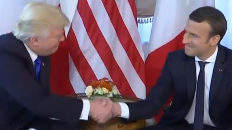 Macron held on tight to Trump's notorious power grip as the two men sat next to each other, the Frenchman's mouth clenched and eyes firmly fixed at the 70-year-old tycoon's squinty stare. (Photo: YouTube videograb) Macron held on tight to Trump's notorious power grip as the two men sat next to each other, the Frenchman's mouth clenched and eyes firmly fixed at the 70-year-old tycoon's squinty stare. (Photo: YouTube videograb)
