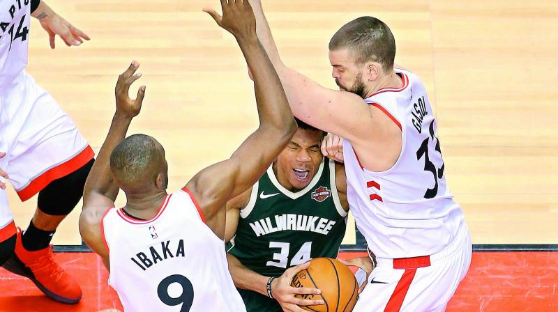 Giannis Antetokounmpo (34) of the Milwaukee Bucks handles the ball against Serge Ibaka and Marc Gasol of the Toronto Raptors during the second half in Game Four of the NBA Eastern Conference Finals in Toronto on Wednesday. (Photo: AFP) Giannis Antetokounmpo (34) of the Milwaukee Bucks handles the ball against Serge Ibaka and Marc Gasol of the Toronto Raptors during the second half in Game Four of the NBA Eastern Conference Finals in Toronto on Wednesday. (Photo: AFP)