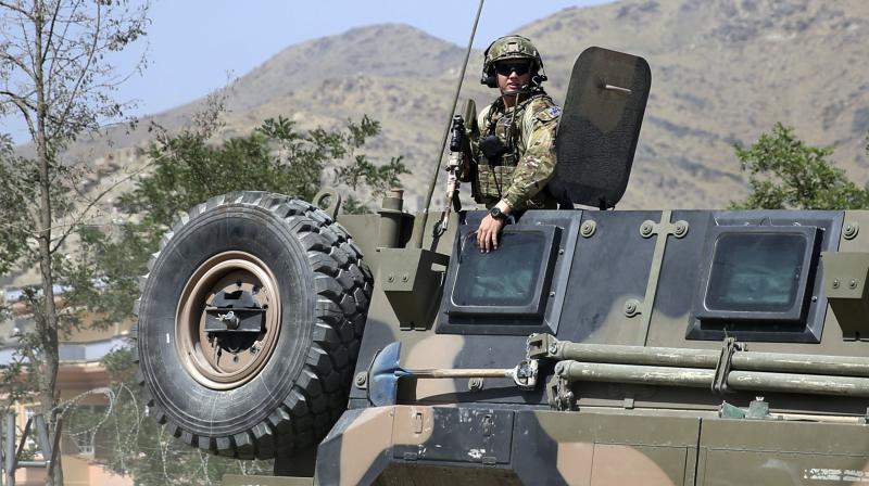 A NATO soldier keeps watch as his vehicle leaves Camp Qargha, west of Kabul, Afghanistan.(Photo: AP) A NATO soldier keeps watch as his vehicle leaves Camp Qargha, west of Kabul, Afghanistan.(Photo: AP)