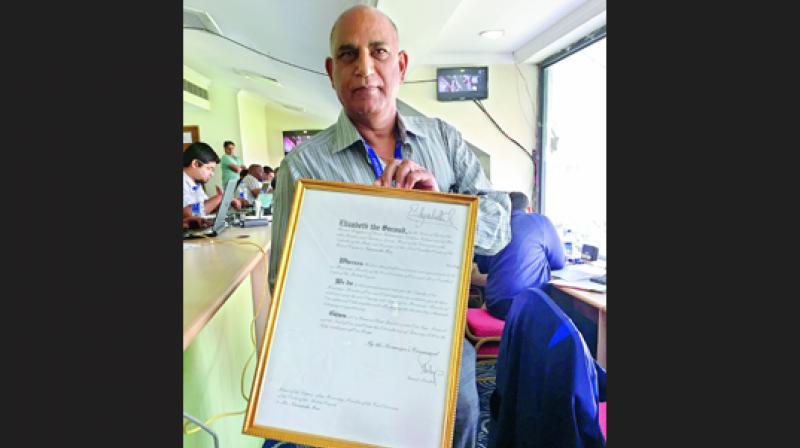 Narasimha Rao shows the MBE citation from Queen Elizabeth Narasimha Rao shows the MBE citation from Queen Elizabeth