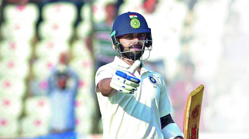 India’s captain Virat Kohli celebrates his century during the first day of the Test against Bangladesh in Hyderabad on Thursday. (Photos: S. Surender Reddy) India’s captain Virat Kohli celebrates his century during the first day of the Test against Bangladesh in Hyderabad on Thursday. (Photos: S. Surender Reddy)
