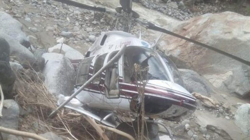 The private helicopter made the landing on the banks of a river when it was on way to Chiwa to distribute relief material among affected people. (Photo: ANI) The private helicopter made the landing on the banks of a river when it was on way to Chiwa to distribute relief material among affected people. (Photo: ANI)