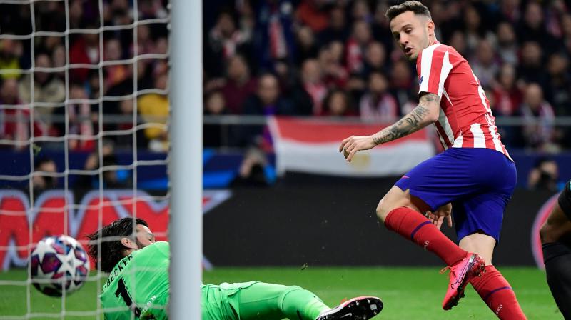 Atletico Madrids Spanish midfielder Saul Niguez scores the opening goal during the UEFA Champions League round of 16 first-leg football match between Club Atletico de Madrid and Liverpool FC at the Wanda Metropolitano stadium in Madrid on February 18, 2020. (AFP)