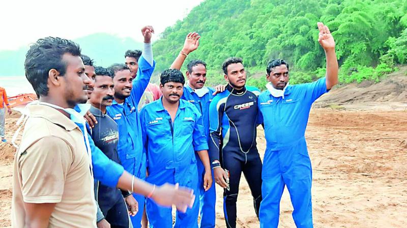The team of divers that helped locate the capsized boat in Godavari breathe a sigh of relief at Katchaluru in East Godavari on Tuesday. (Photo: DC) The team of divers that helped locate the capsized boat in Godavari breathe a sigh of relief at Katchaluru in East Godavari on Tuesday. (Photo: DC)