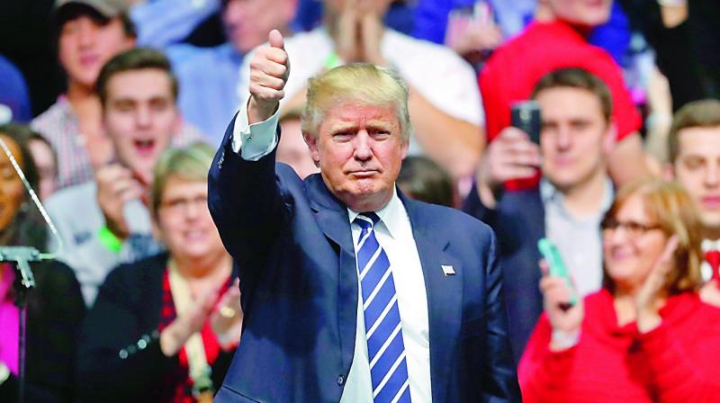 President-elect Donald Trump gives a thumbs up to supporters during a rally in Michigan. (Photo: AP) President-elect Donald Trump gives a thumbs up to supporters during a rally in Michigan. (Photo: AP)