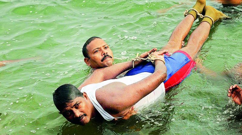 File photos of swimmer and constable L. Uma Maheswara Rao, who died in river Krishna at the practice time due to cardiac arrest in Vijayawada on Sunday. (Photo: DC) File photos of swimmer and constable L. Uma Maheswara Rao, who died in river Krishna at the practice time due to cardiac arrest in Vijayawada on Sunday. (Photo: DC)