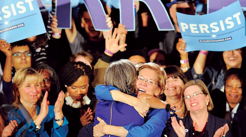 Senator Elizabeth Warren embraces Congresswoman Katherine Clark before she addresses the audience in Boston, Massachusetts (Photo: AFP) Senator Elizabeth Warren embraces Congresswoman Katherine Clark before she addresses the audience in Boston, Massachusetts (Photo: AFP)