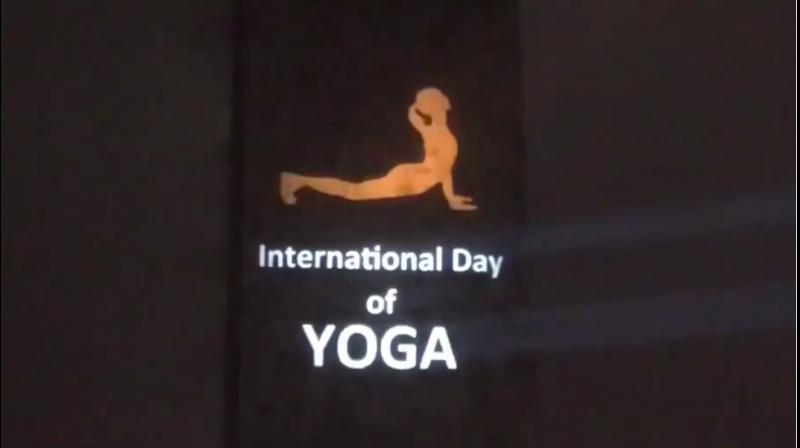 The United Nations headquarters was lit up with postures of 'Surya Namaskar' and the message of 'Yoga for Climate Action' as India's Permanent Mission to the UN kick-started its celebrations for the 5th International Day of Yoga. (Photo: Twitter) The United Nations headquarters was lit up with postures of 'Surya Namaskar' and the message of 'Yoga for Climate Action' as India's Permanent Mission to the UN kick-started its celebrations for the 5th International Day of Yoga. (Photo: Twitter)