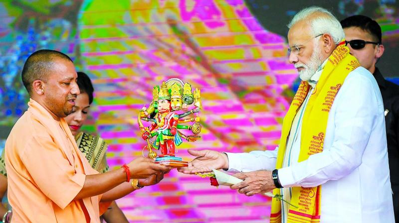 Prime Minister Narendra Modi (right), Uttar Pradesh CM Yogi Adityanath in Varanasi, Tuesday. (Photo: PTI) Prime Minister Narendra Modi (right), Uttar Pradesh CM Yogi Adityanath in Varanasi, Tuesday. (Photo: PTI)