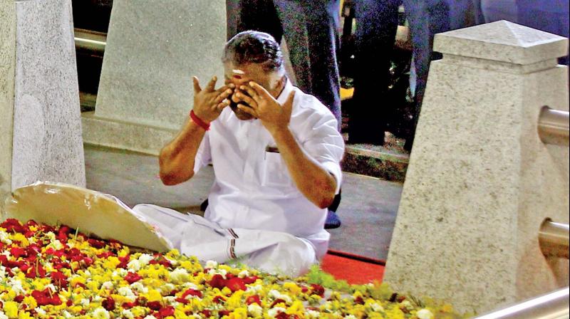 Caretaker Chief Minister O. Panneerselvam sitting in a meditation in front of late J. Jayalalithaa’s burial site at the Marina Beach in Chennai on Tuesday. (Photo: N. Sampath) Caretaker Chief Minister O. Panneerselvam sitting in a meditation in front of late J. Jayalalithaa’s burial site at the Marina Beach in Chennai on Tuesday. (Photo: N. Sampath)