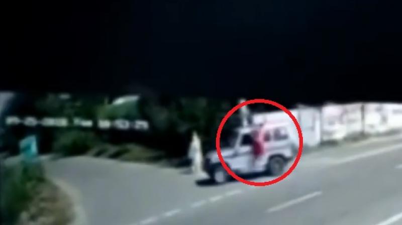 A village CCTV footage purportedly showed the woman lying on top of the vehicle and then falling off when it took a sharp turn. (YouTube Screengrab) A village CCTV footage purportedly showed the woman lying on top of the vehicle and then falling off when it took a sharp turn. (YouTube Screengrab)