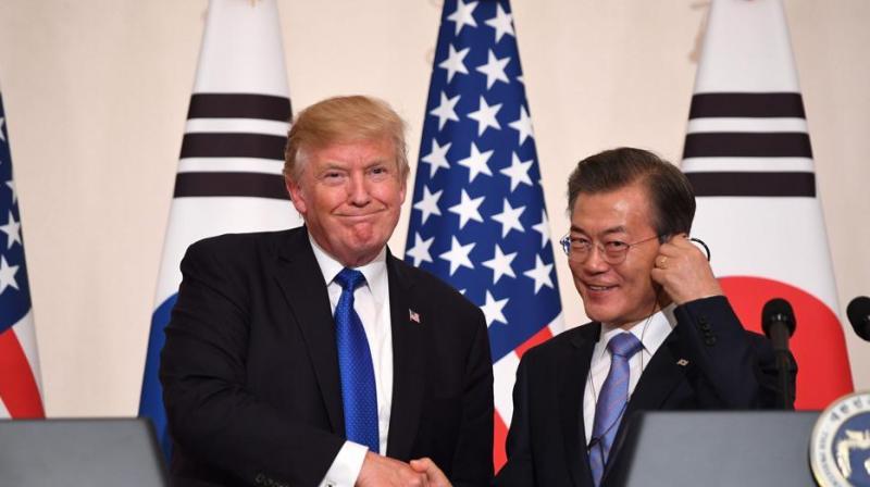 US President Donald Trump (L) shakes hands with South Korea's President Moon Jae-In during a joint press conference at the presidential Blue House in Seoul on Tuesday. (Photo: AFP) US President Donald Trump (L) shakes hands with South Korea's President Moon Jae-In during a joint press conference at the presidential Blue House in Seoul on Tuesday. (Photo: AFP)
