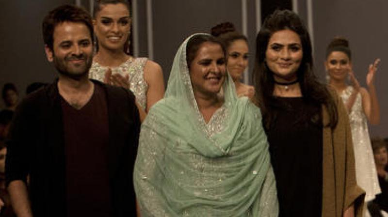 Pakistan's gangrape victim Mukhtar Mai, centre, walks with models during a fashion show in Karachi. (Photo: AP) Pakistan's gangrape victim Mukhtar Mai, centre, walks with models during a fashion show in Karachi. (Photo: AP)