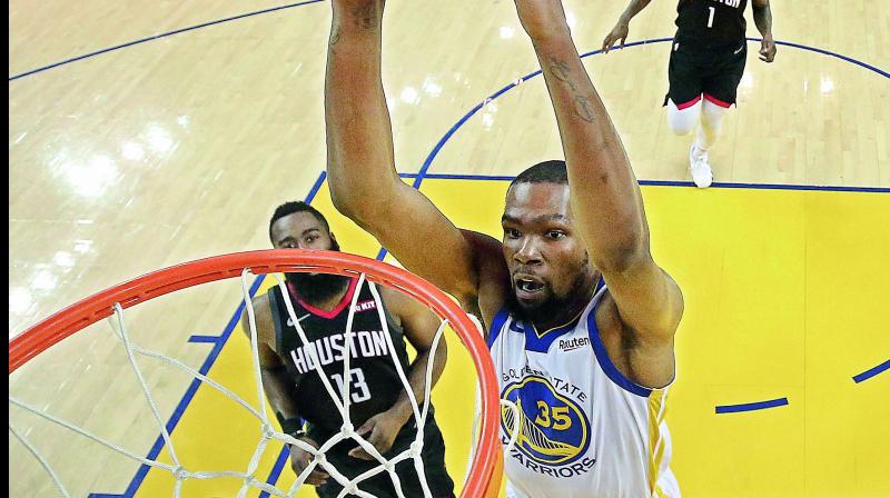 Golden State Warriors’ Kevin Durant scores over Houston Rockets’ James Harden (13) during the first half of Game Five of a second-round NBA basketball playoff series in Oakland on Thursday. (Photo: AP) Golden State Warriors’ Kevin Durant scores over Houston Rockets’ James Harden (13) during the first half of Game Five of a second-round NBA basketball playoff series in Oakland on Thursday. (Photo: AP)