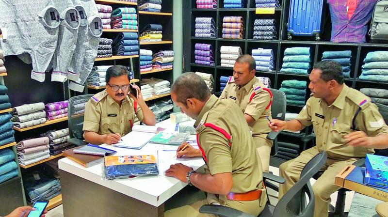 Legal metrology officials checking the rate tags at a store. Legal metrology officials checking the rate tags at a store.
