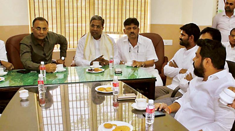 Senior Congress leaders Dinesh Gundurao, Siddaramaiah and D.K. Shivakumar at a party meeting in Bengaluru on Friday Senior Congress leaders Dinesh Gundurao, Siddaramaiah and D.K. Shivakumar at a party meeting in Bengaluru on Friday