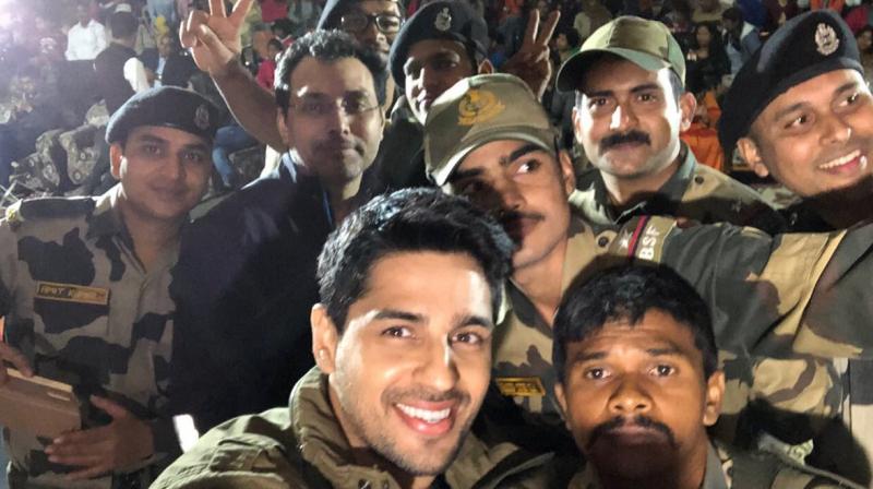 Sidharth Malhotra and Neeraj Pandey with BSF jawans. Sidharth Malhotra and Neeraj Pandey with BSF jawans.