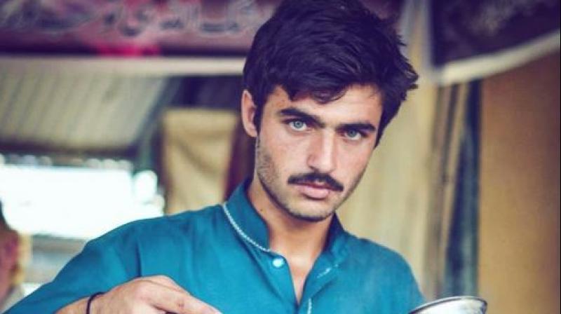A candid photo of Pakistani chai wala, Arshad Khan (centre), hit the internet, sparking debates on reverse sexism, class privileges, and objectification in Pakistan. (Photo: AFP) A candid photo of Pakistani chai wala, Arshad Khan (centre), hit the internet, sparking debates on reverse sexism, class privileges, and objectification in Pakistan. (Photo: AFP)